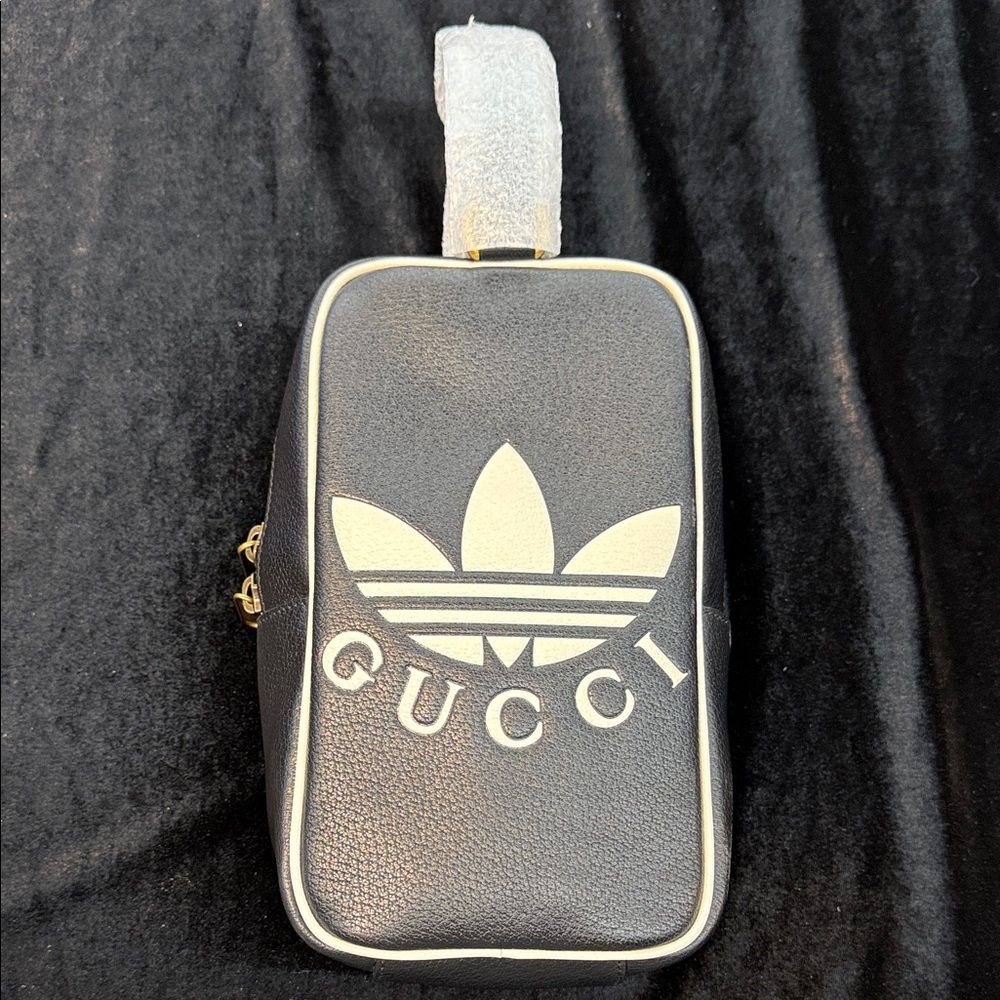 Gucci x Adidas top handle bag in black textured leather.